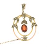 An early 20th century garnet and split pearl openwork pendant.