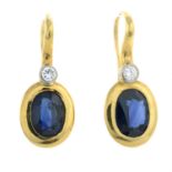 A pair of oval-shape sapphire and brilliant-cut diamond earrings.