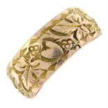 An early 20th century 9ct gold foliate engraved band ring.