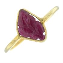 A foliate carved ruby cabochon single-stone ring.