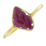 A foliate carved ruby cabochon single-stone ring.