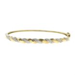 A 9ct gold pavé-set diamond hinged bangle.