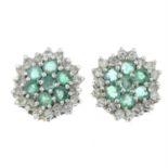 A pair of emerald and diamond cluster earrings.