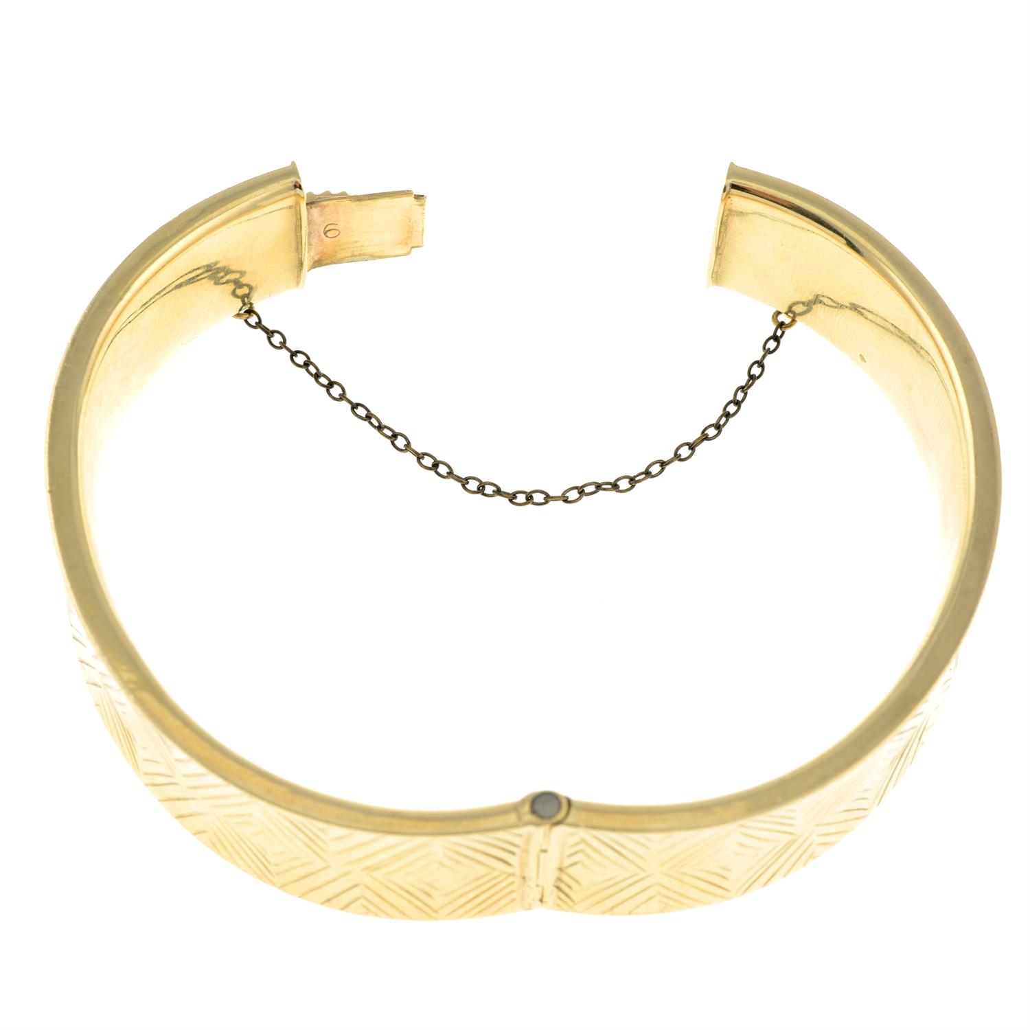 A 9ct gold hinged bangle, with cross motif. - Image 2 of 2