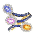 A vari-hue sapphire and diamond crossover cluster ring.