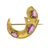 A late 19th century gold garnet foliate brooch.