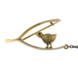 An early 20th century 9ct gold garnet eye bird and wishbone brooch.