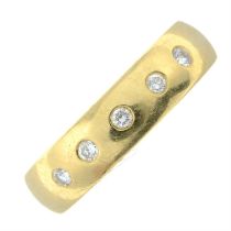 An 18ct gold band ring, with diamond highlights.