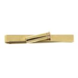 A 9ct gold tie slide, with shotgun cartridge decoration, by Deakin & Francis.