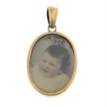 An early 20th century 9ct gold double-sided photo locket pendant.