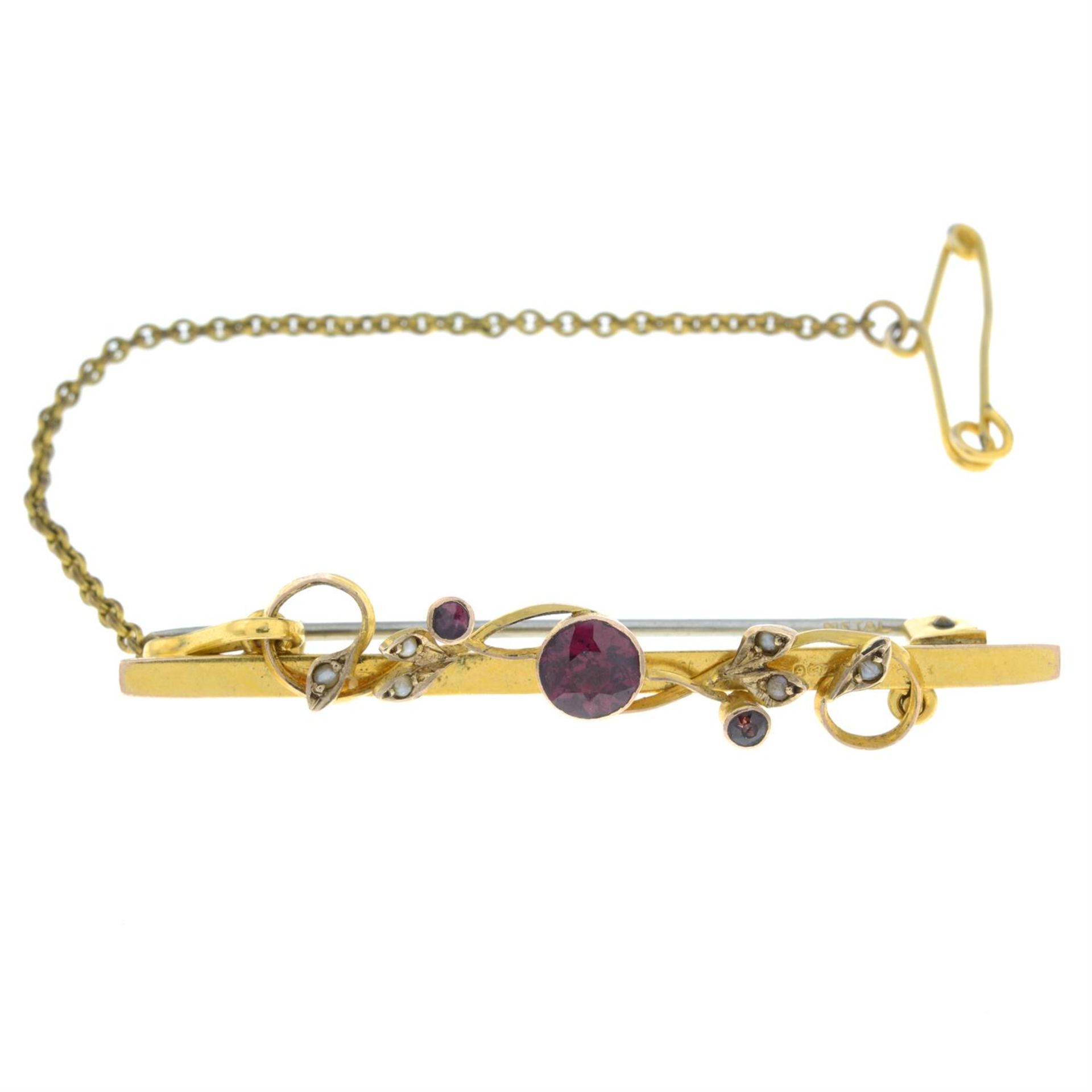 An early 20th century 9ct gold garnet and split pearl bar brooch.