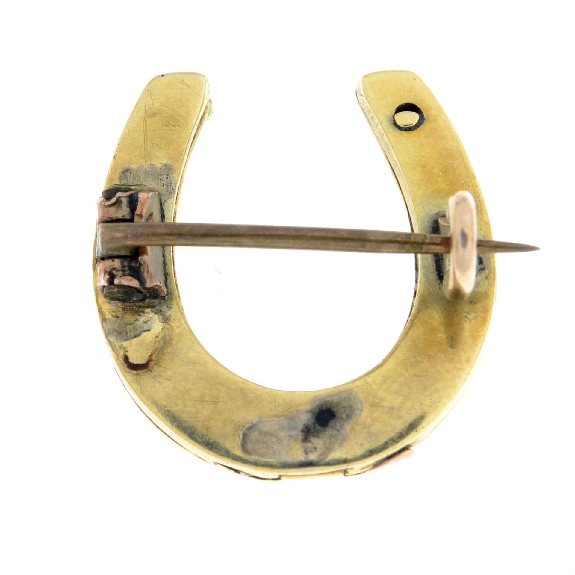 An early 20th century gold and blue enamel horseshoe brooch. - Image 2 of 2
