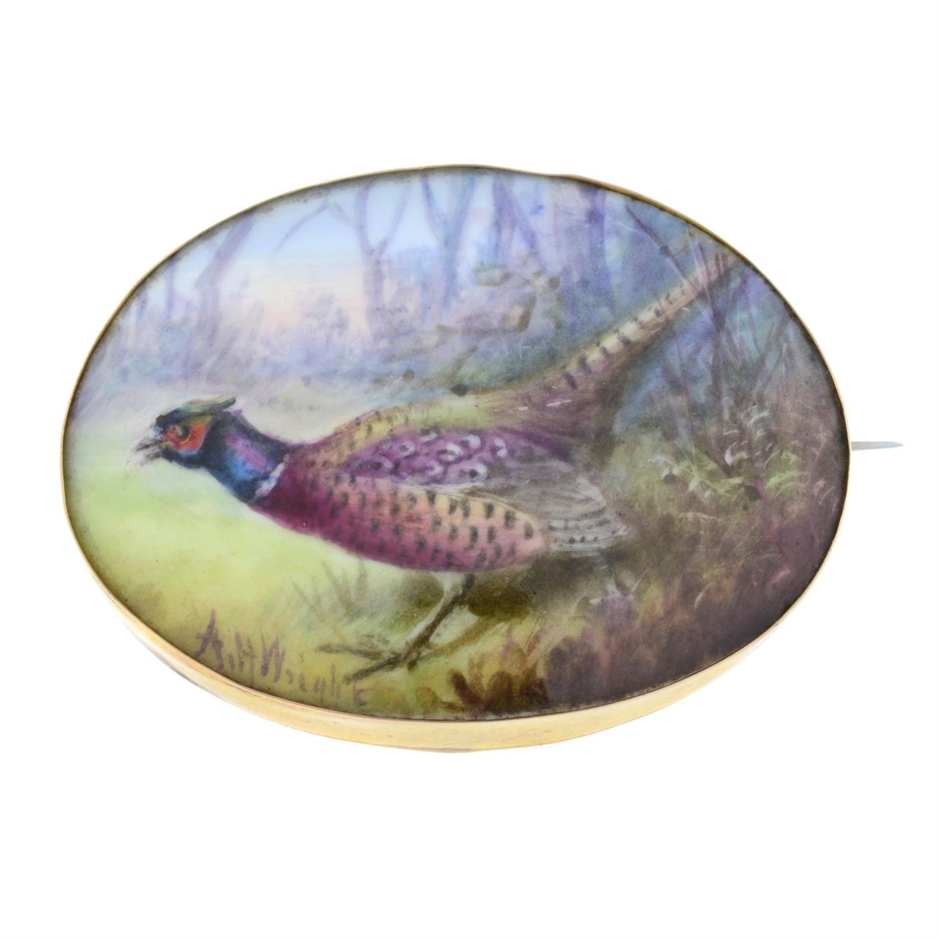 An early 20th century gold and enamel brooch, painted to depict a pheasant.
