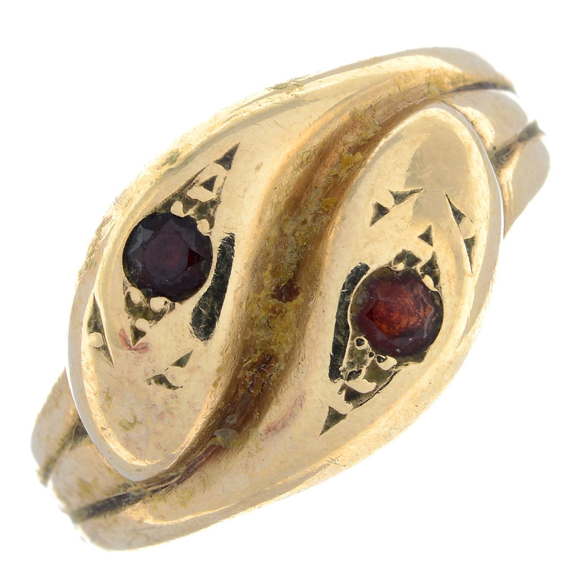 A 9ct gold garnet accent double snake dress ring.