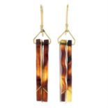 A pair of tortoiseshell drop earrings.