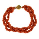An early 20th century multi-row coral bracelet, with cannetille push-piece clasp.