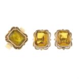 A synthetic yellow sapphire ring, with a pair of matching earrings.