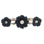 A late Victorian onyx and diamond mourning bar brooch, carved to depict three flowers.