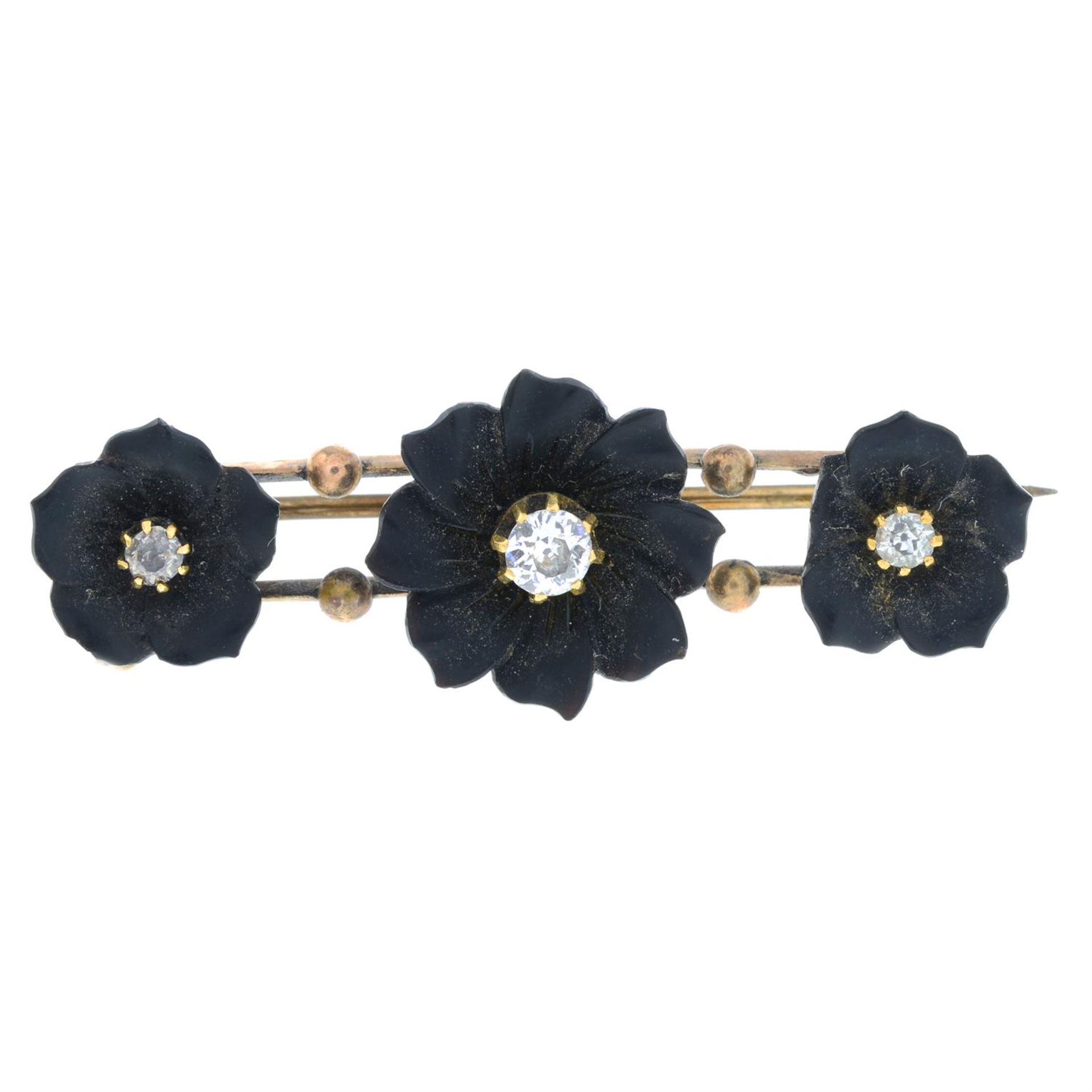 A late Victorian onyx and diamond mourning bar brooch, carved to depict three flowers.