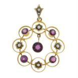 An early 20th century 9ct gold garnet and seed pearl openwork pendant.