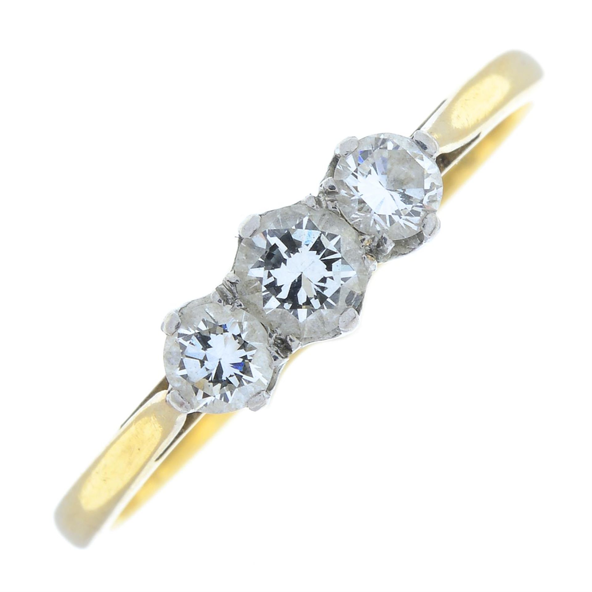 A brilliant-cut diamond three-stone ring.