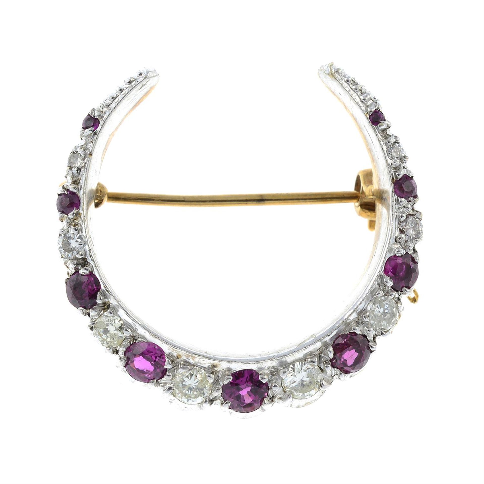 A 9ct gold ruby and diamond crescent brooch.