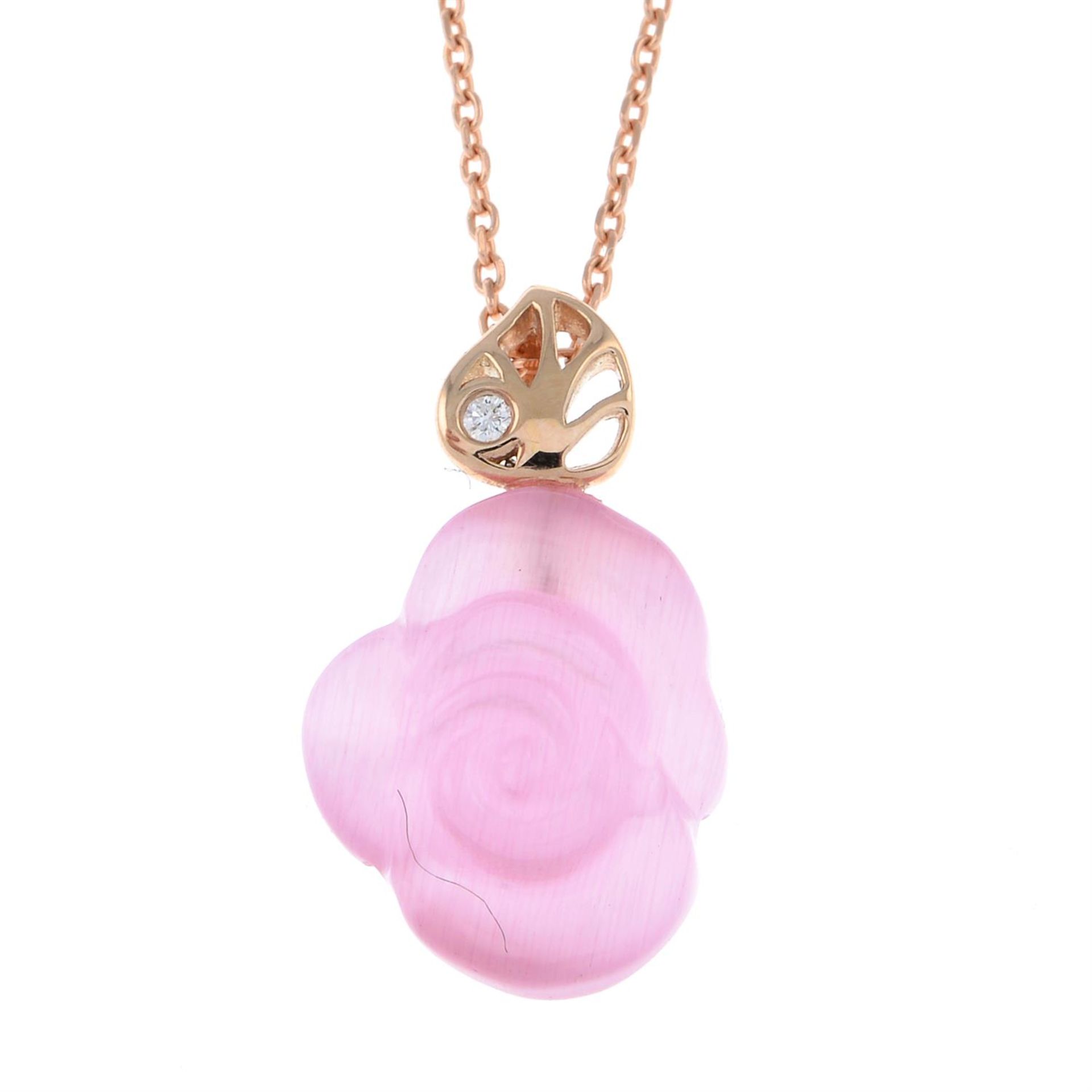 A carved pink paste and diamond rose pendant, with chain.