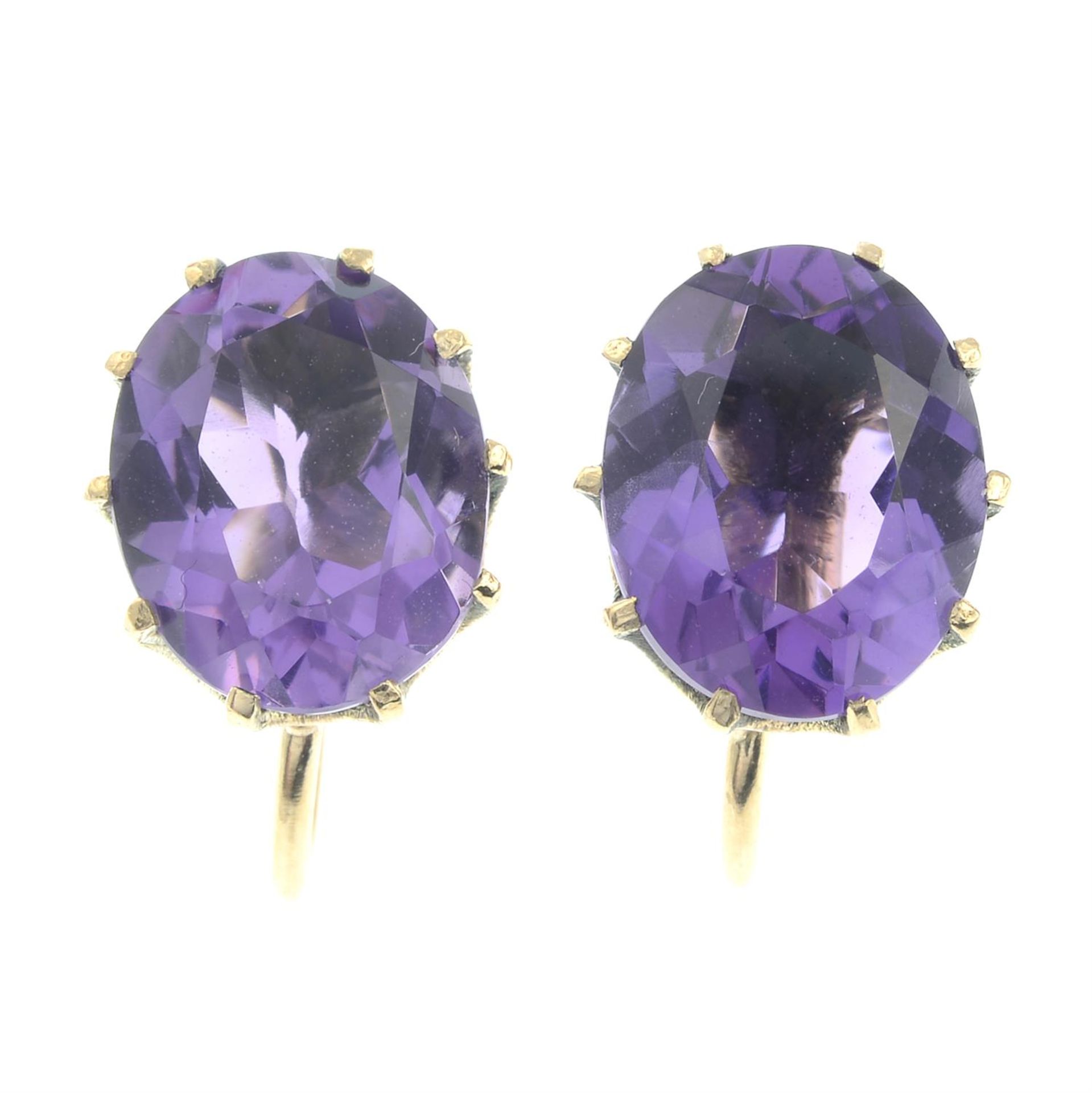 A pair of amethyst single-stone stud earrings.