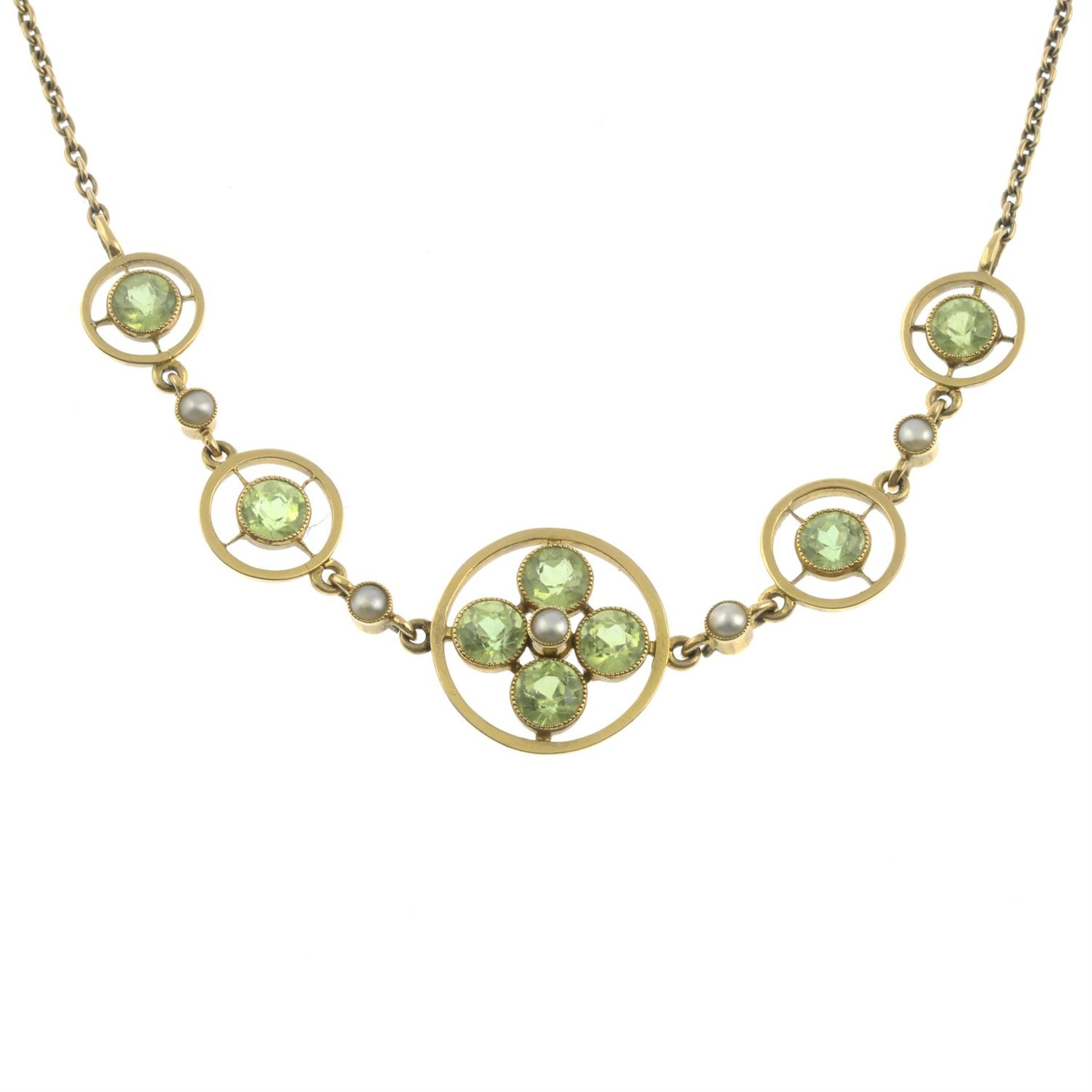 An early 20th century 9ct gold peridot and split pearl openwork necklace.