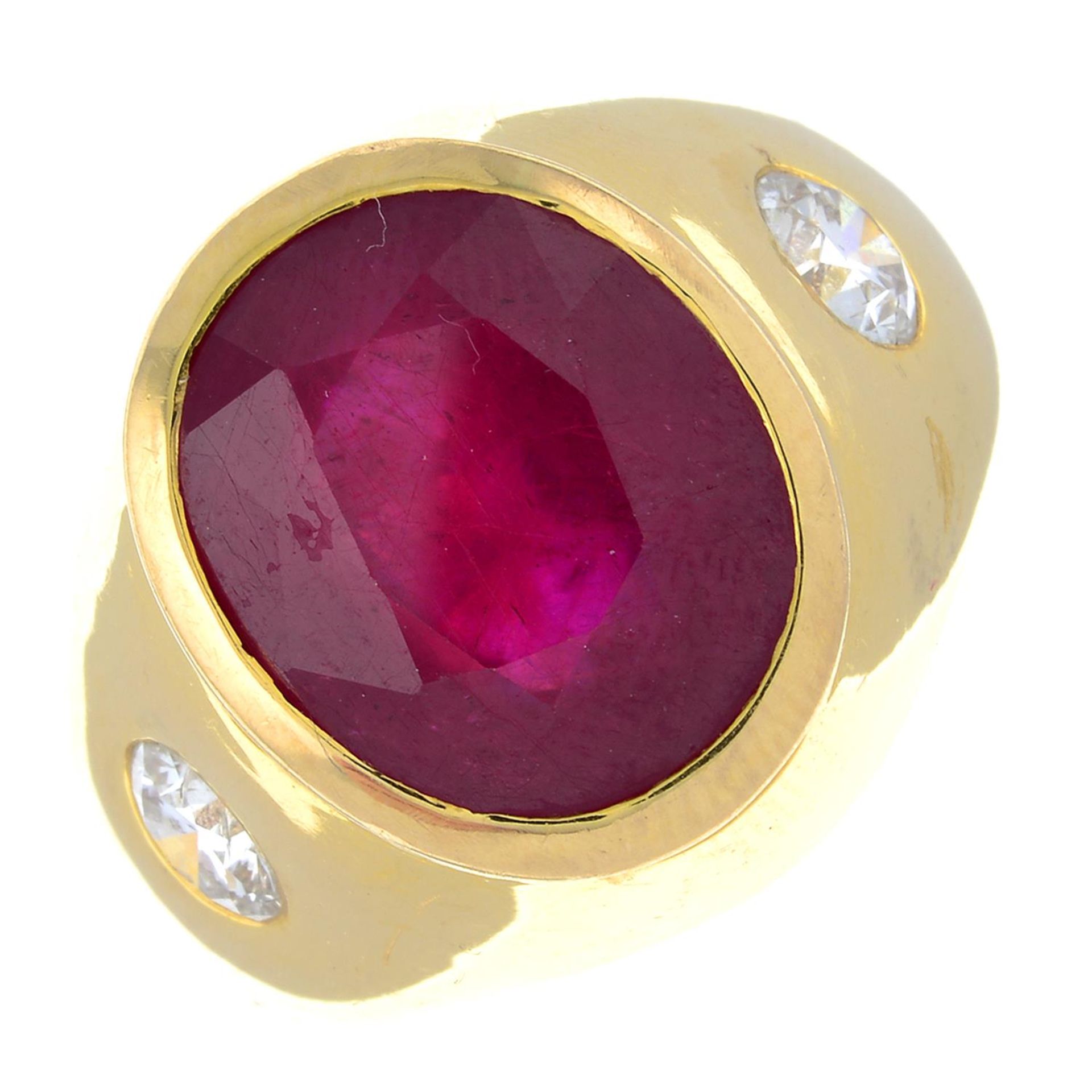 A glass-filled ruby and diamond three-stone ring.