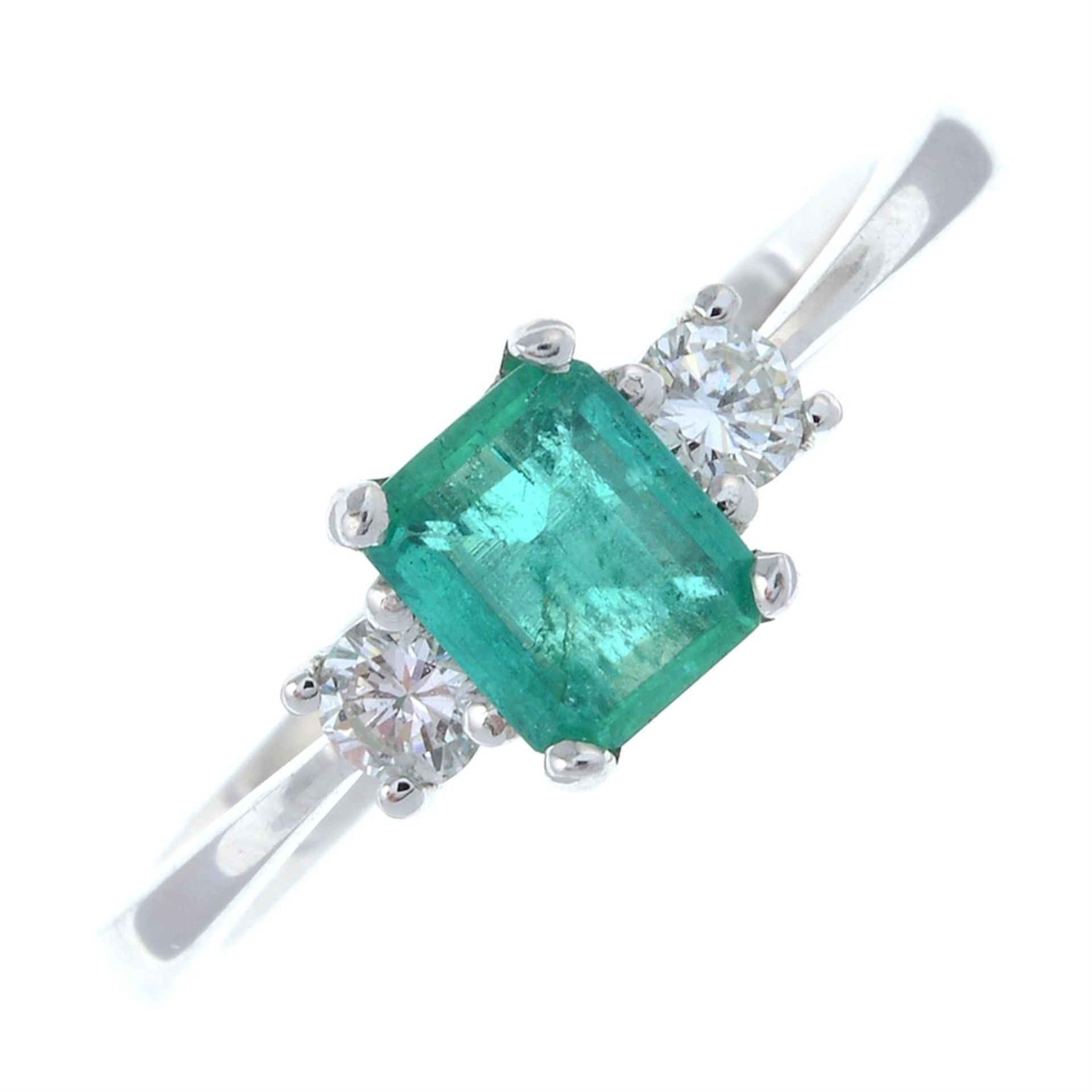 An 18ct gold emerald and diamond three-stone ring.