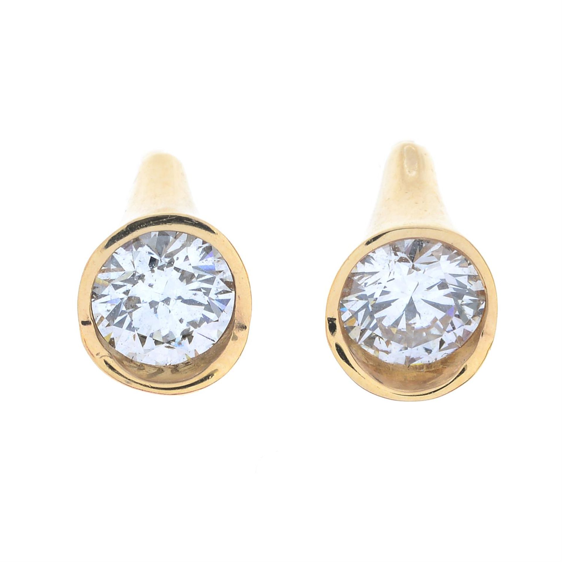 A pair of brilliant-cut diamond stud earrings.