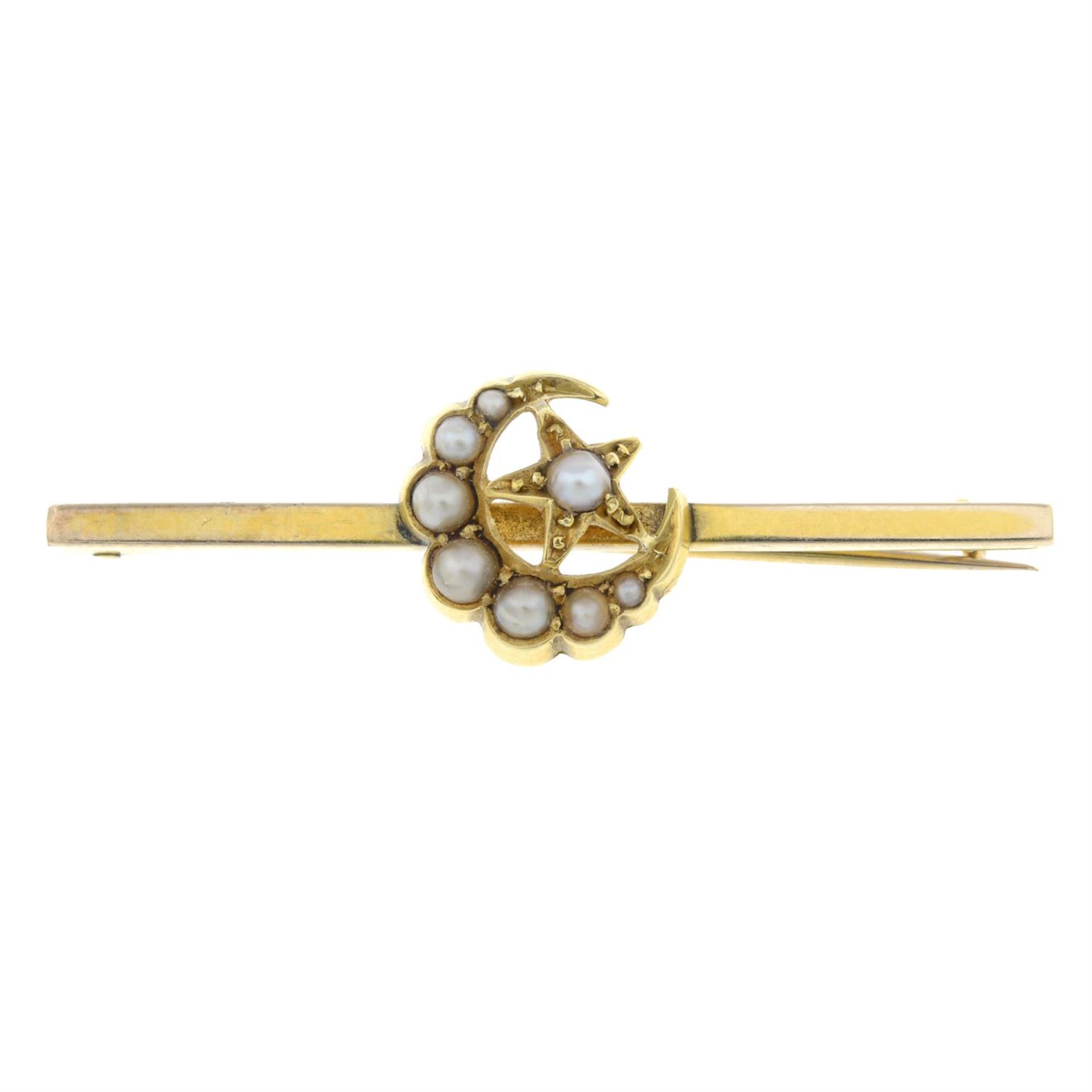 An early 20th century bar brooch, with split pearl crescent moon and star highlight.