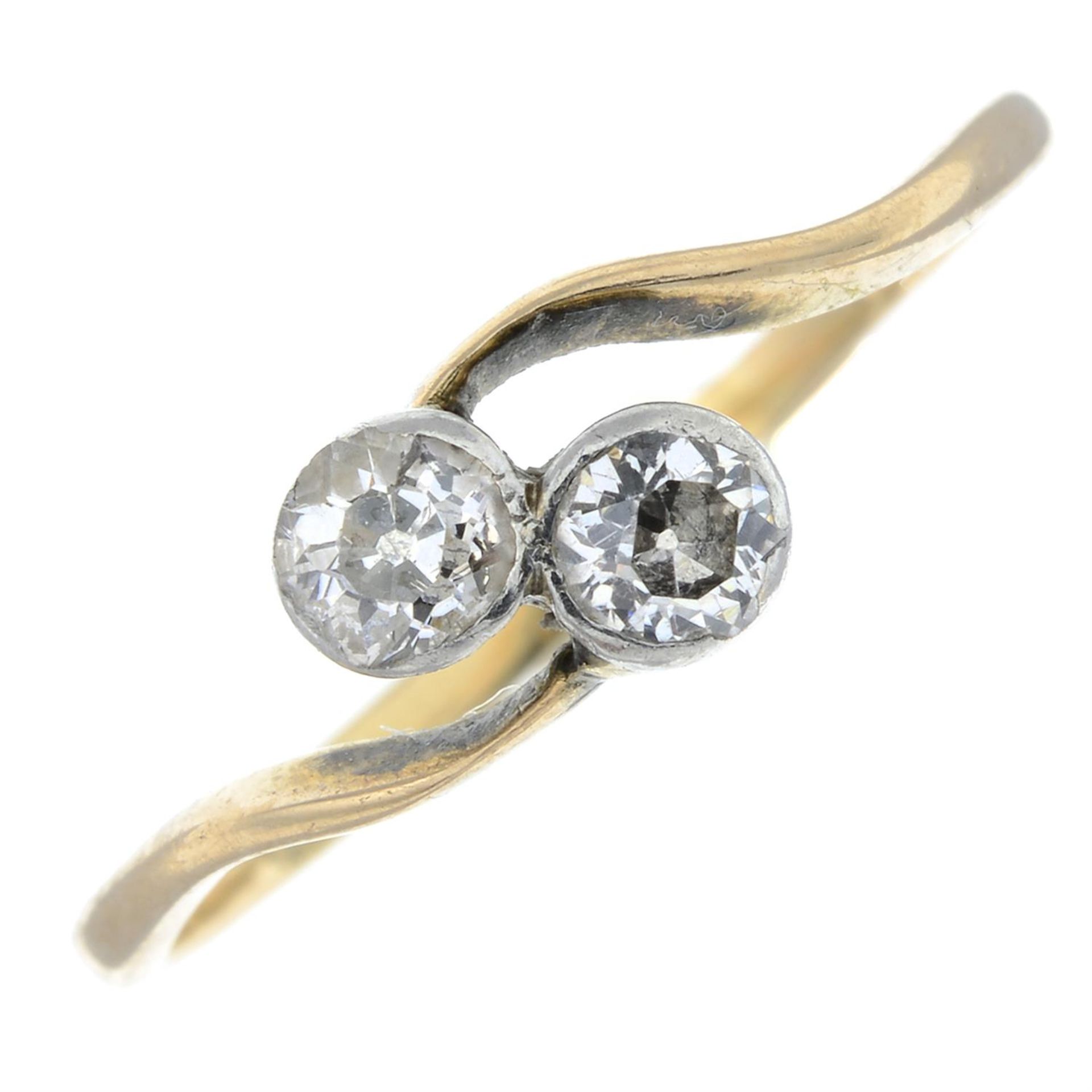 A mid 20th century old-cut diamond two-stone crossover ring.