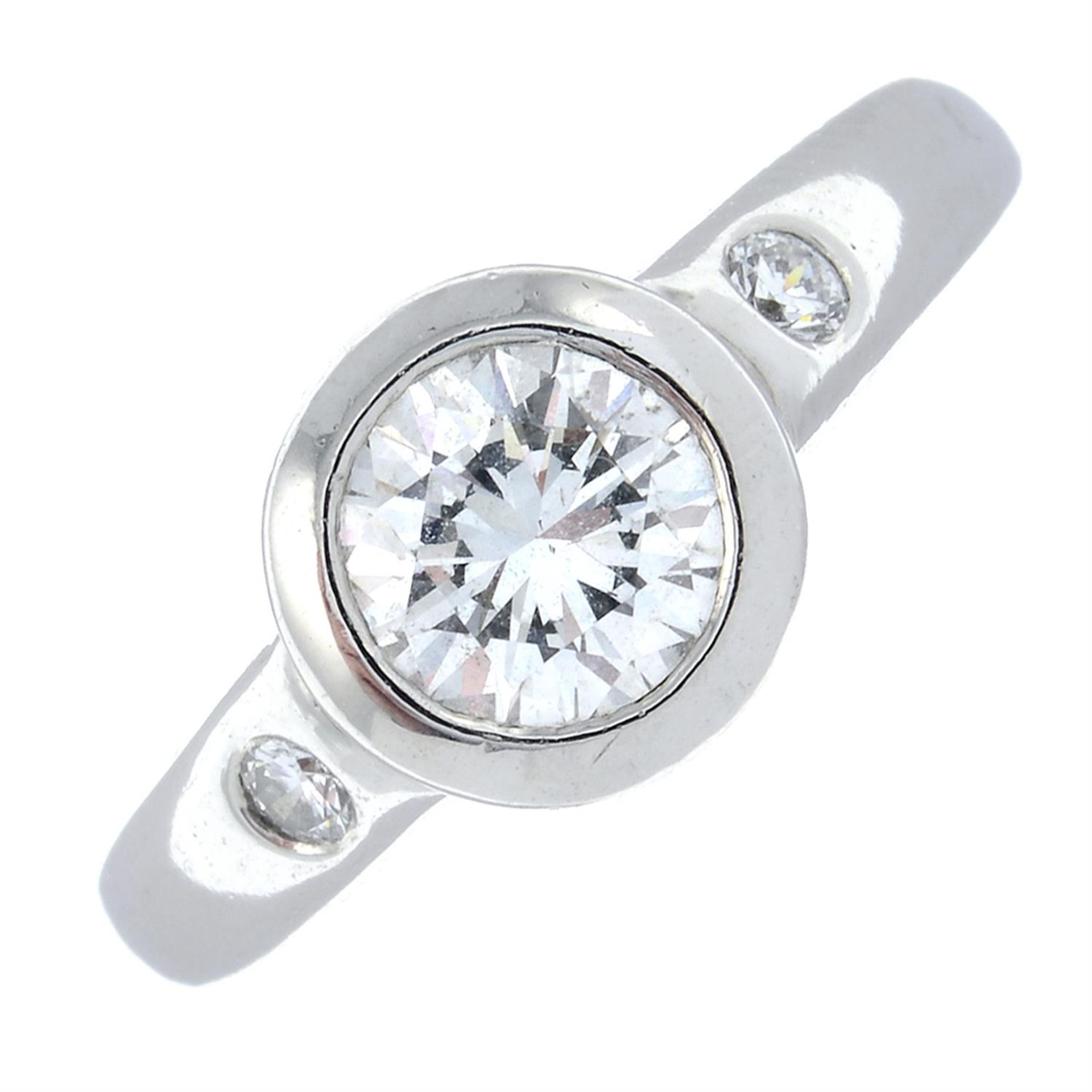 A platinum brilliant-cut diamond single-stone ring, with diamond shoulders.