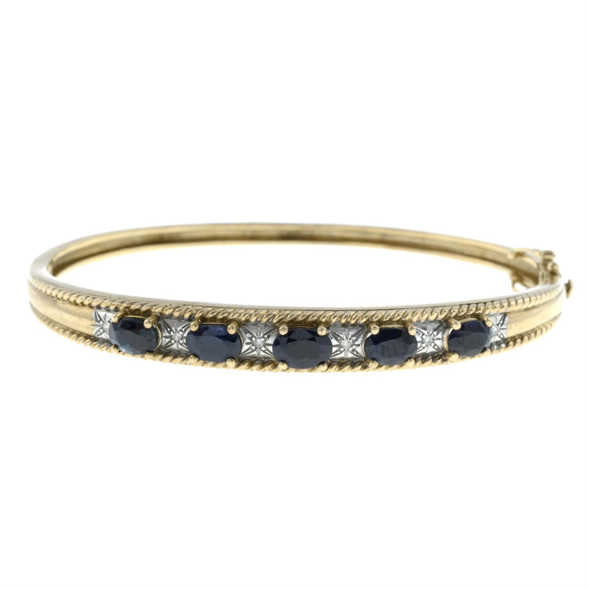 A 9ct gold sapphire and diamond hinged bangle.