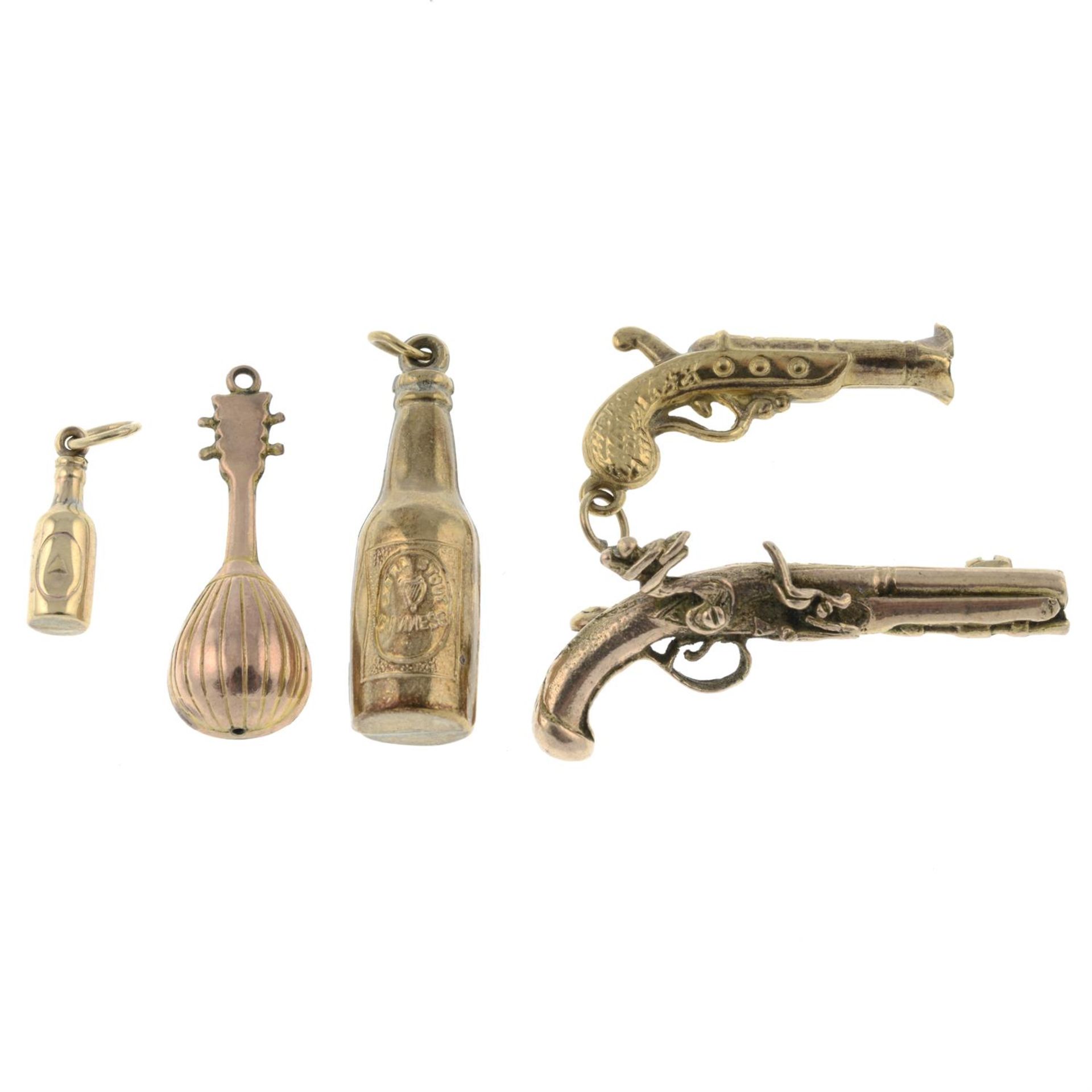 Three 9ct gold charms, together with a further charm and a 9ct gold pistol brooch. - Image 2 of 2