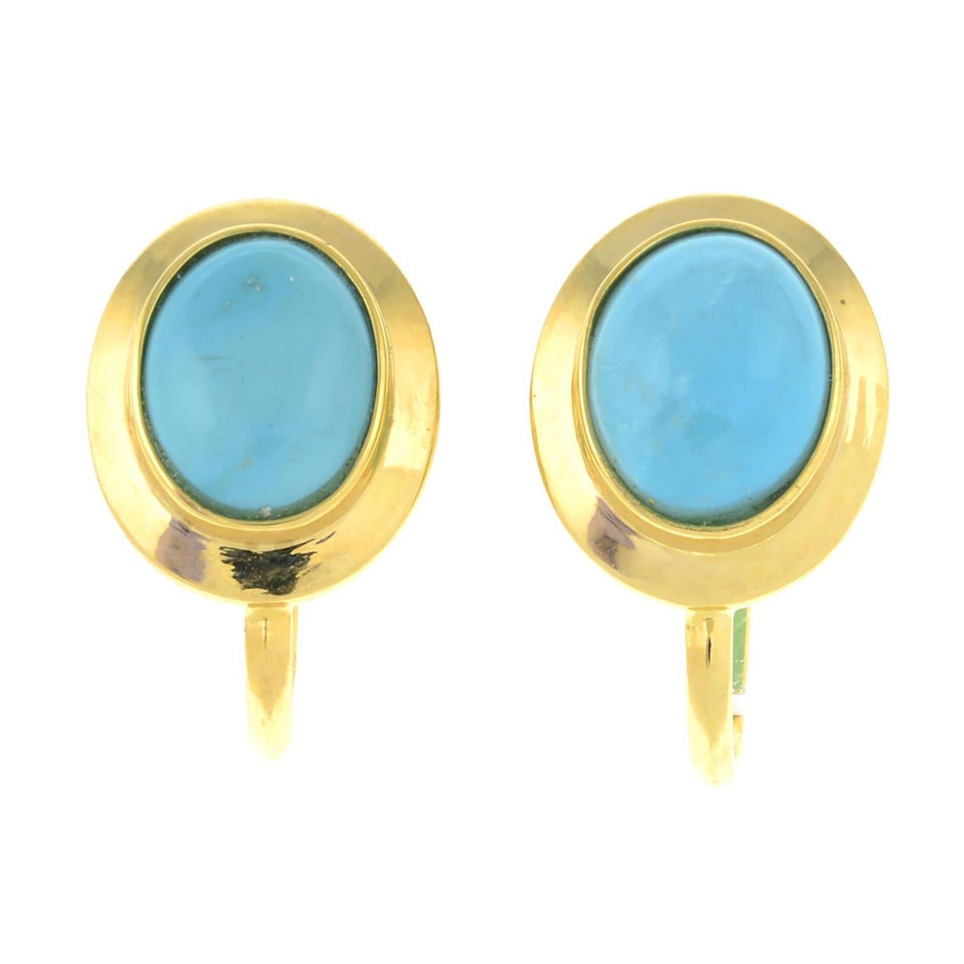 A pair of turquoise screw-back earrings.