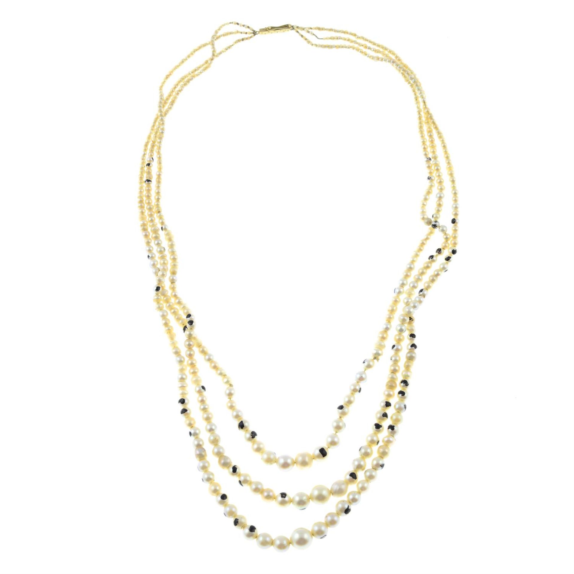 An early 20th century graduated natural, cultured and imitation pearl three-strand necklace.