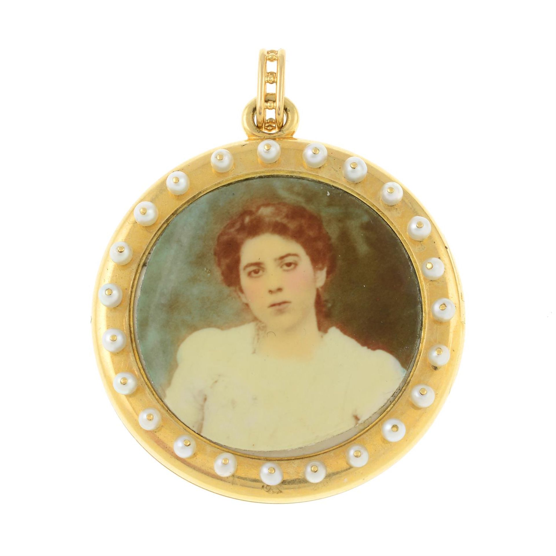 An early 20th century gold ruby and split pearl locket.