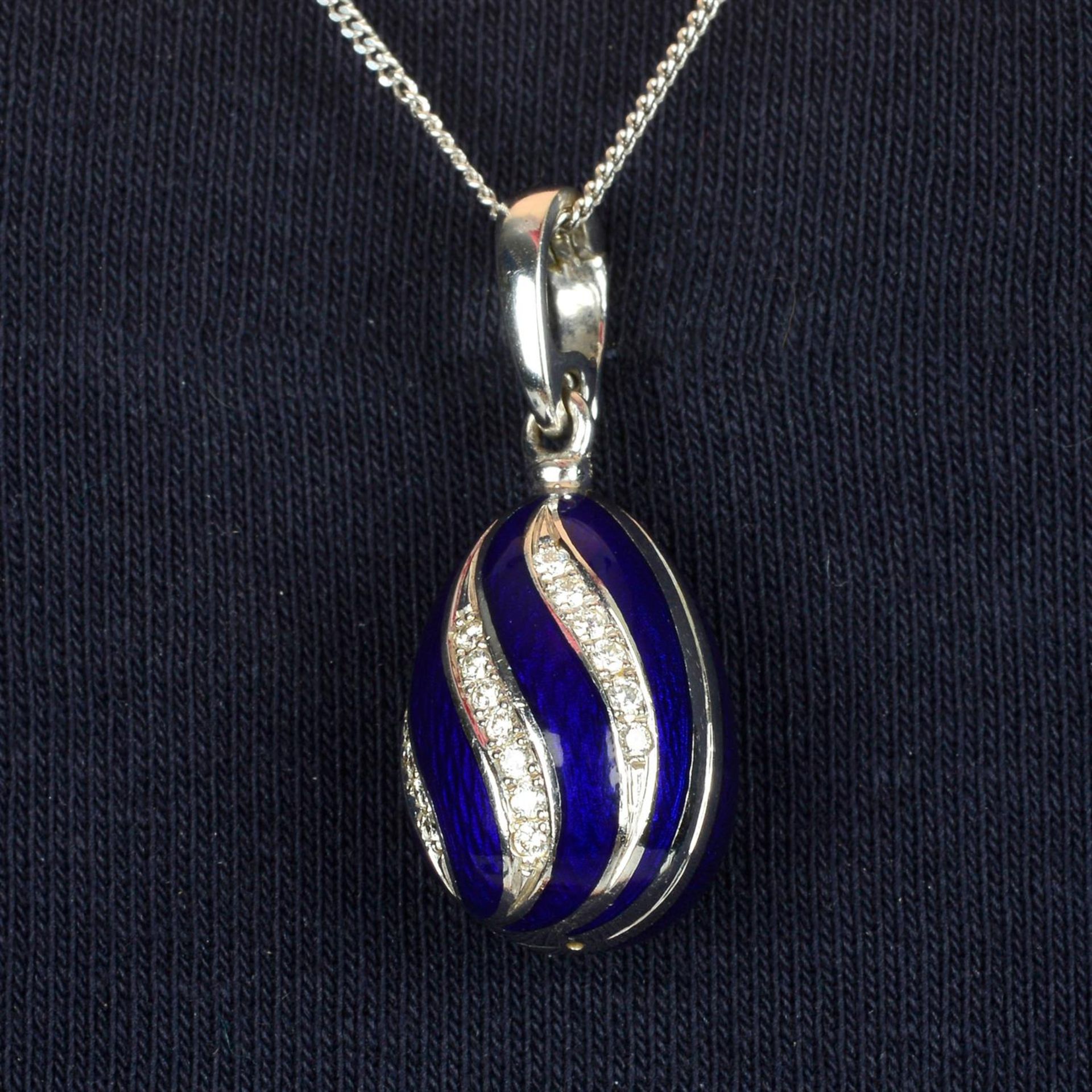 A limited edition 18ct gold brilliant-cut diamond and blue enamel egg pendant, by Fabergé.