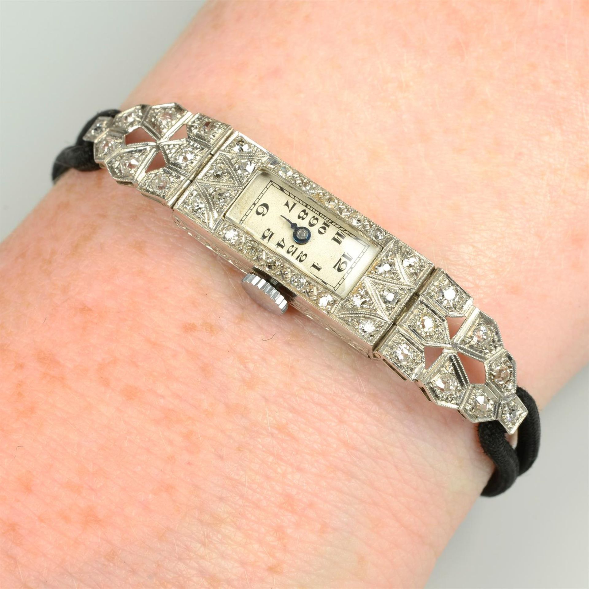 A lady's Art Deco platinum old-cut diamond wrist watch, with black fabric bracelet.