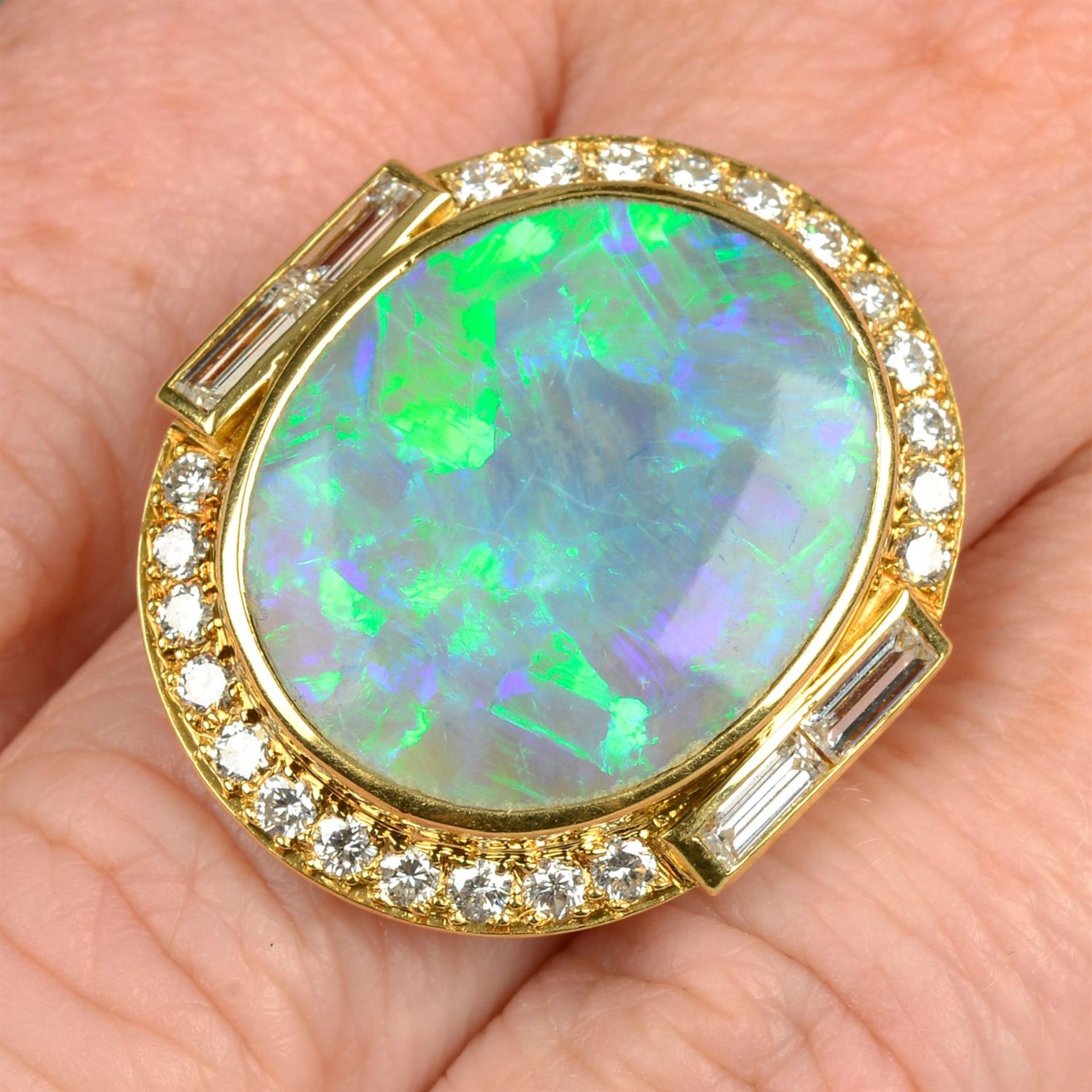 An opal dress ring, with baguette and brilliant-cut diamond surround.
