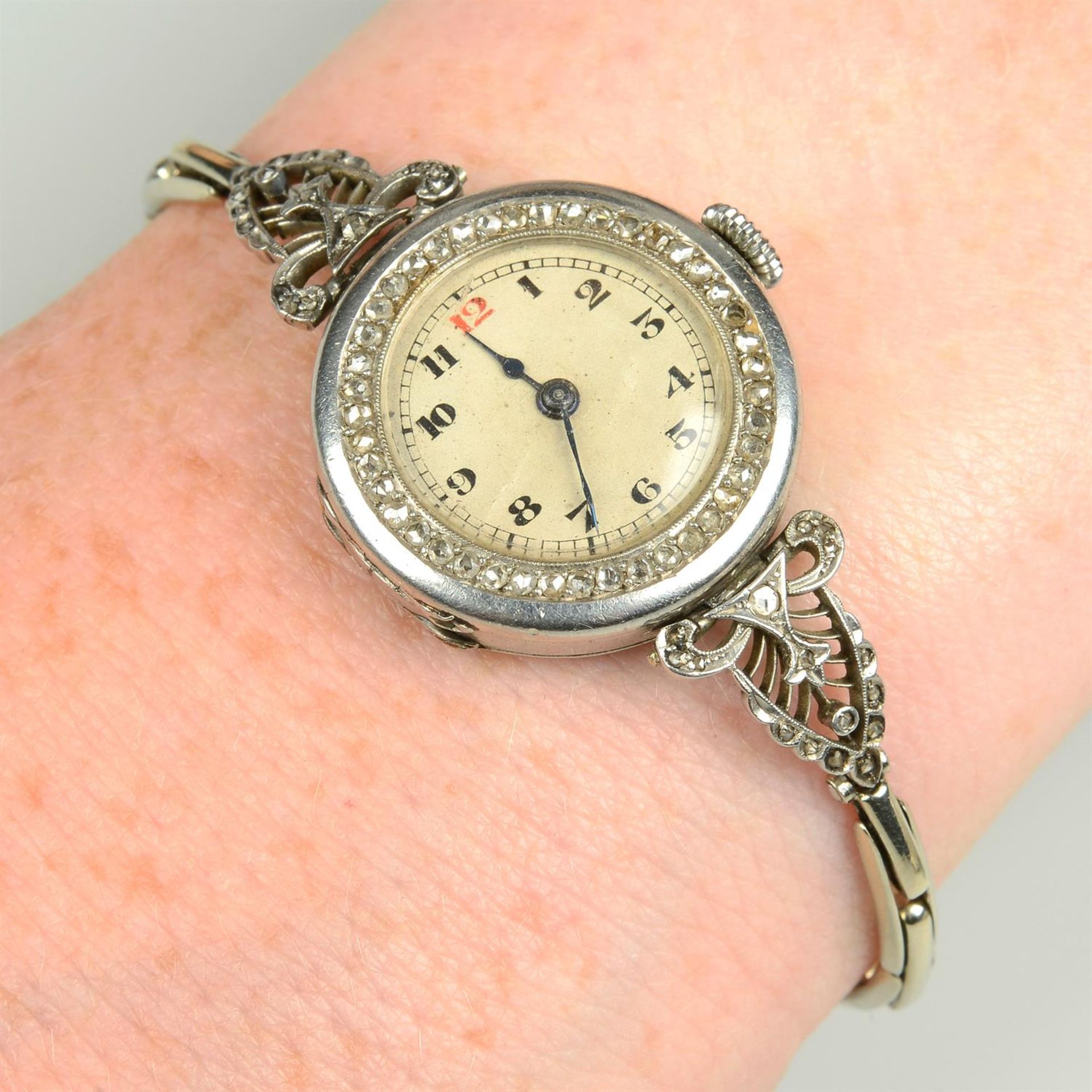 An early 20th century lady's platinum watch, with rose-cut diamond bezel and pierced lugs,