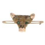 A bone and paste animal's mask brooch.