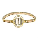 An early 20th century 9ct gold split pearl monogram expandable bracelet.