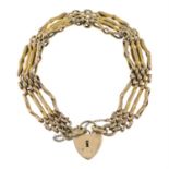 A 9ct gold fancy-link bracelet, with heart-shape padlock clasp.