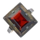 A garnet single-stone ring.