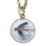 A 1970s 9ct gold mother-of-pearl fly fishing charm pendant, on trace-link chain.