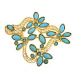 A reconstituted turquoise stylised floral brooch.
